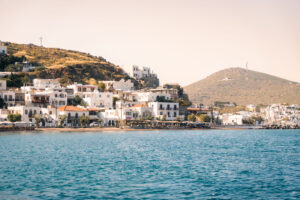 Whitewashed buildings in the Bay of Patmos against the vibrant blue sea