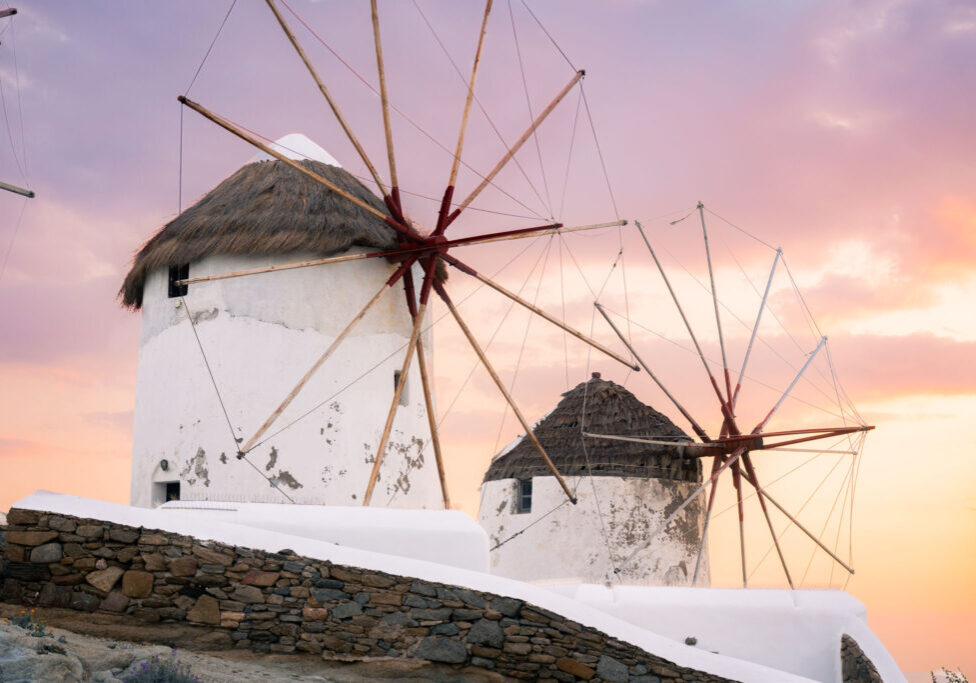 Windmills pictured during a warm sunset in Mykonos